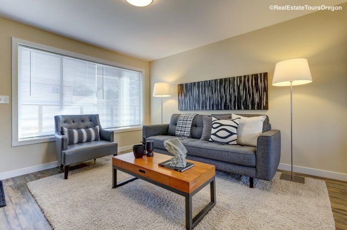 A living room with a couch , chair and coffee table