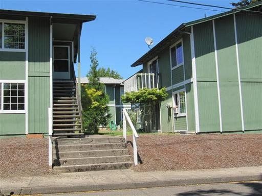 A green building with stairs leading up to it