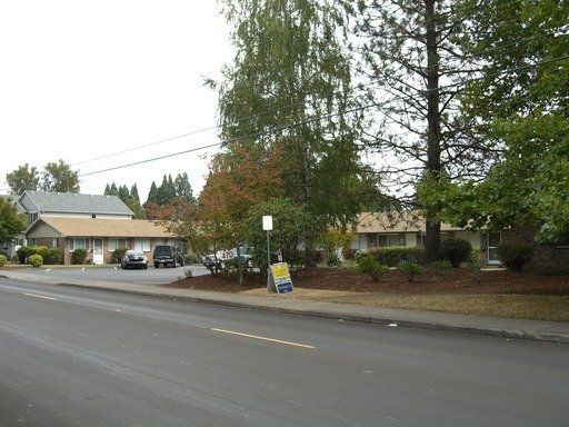 A for sale sign is on the side of the road