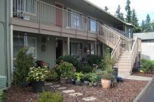 A large apartment building with stairs leading up to the second floor.