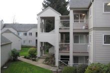 A large apartment building with a lot of windows and balconies.