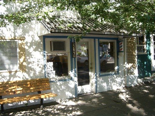 A barber shop with a wooden bench in front of it