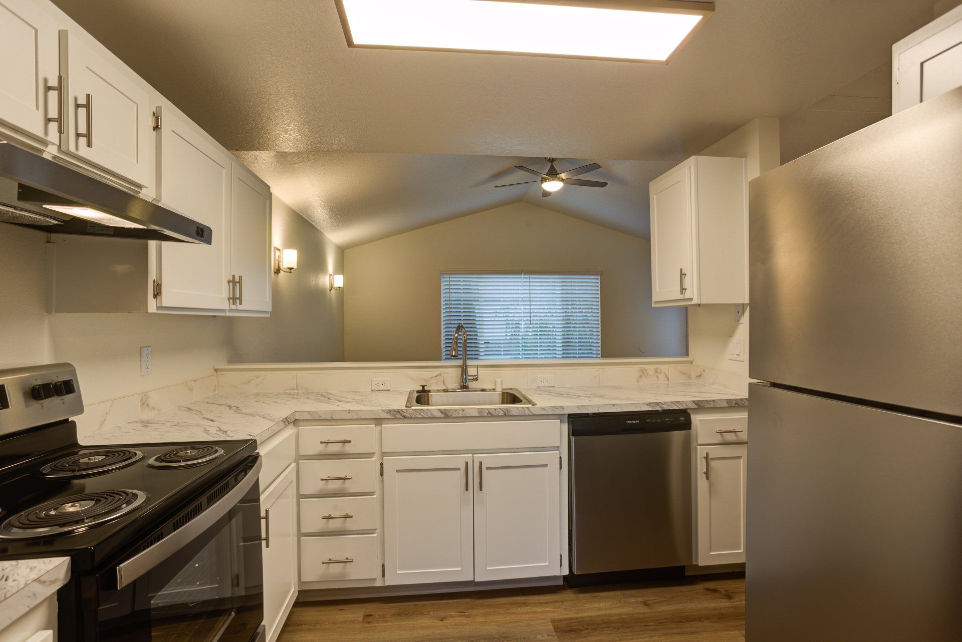 A kitchen with white cabinets and stainless steel appliances