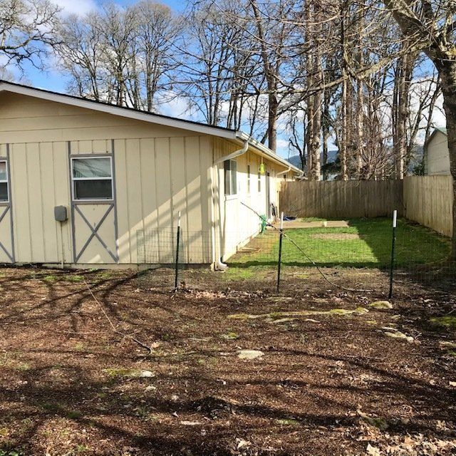 A small house with a fence in front of it