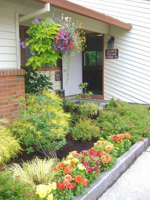 The front of a house with flowers in front of it