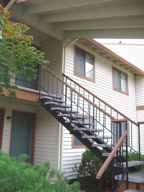 A building with stairs leading up to the second floor