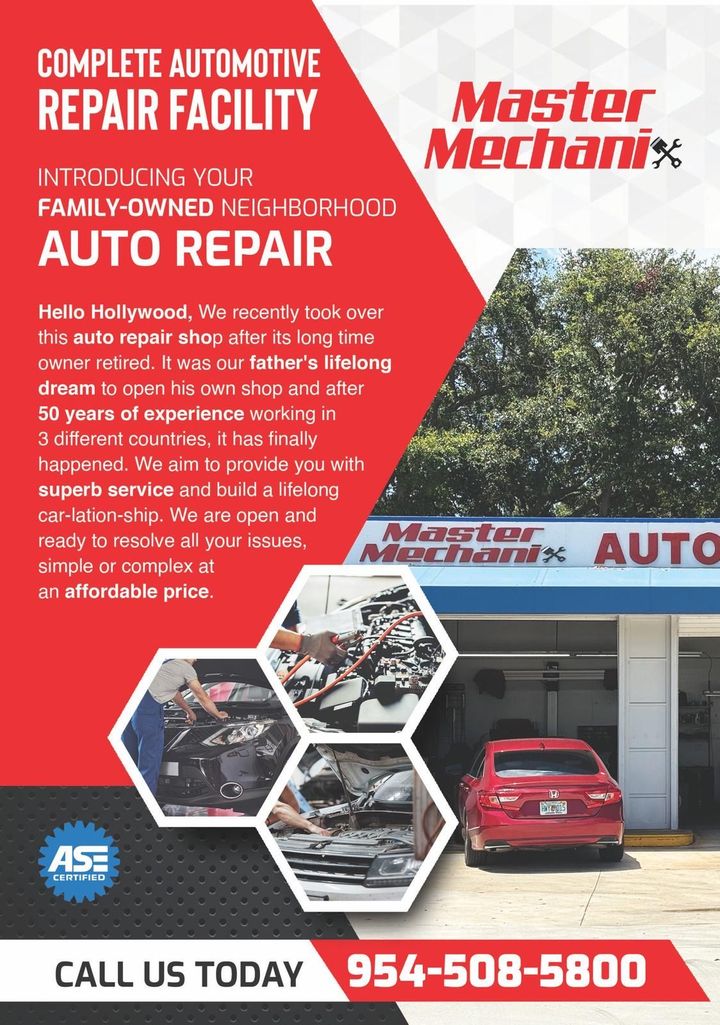 A red car is parked in front of a master mechanic auto repair facility.