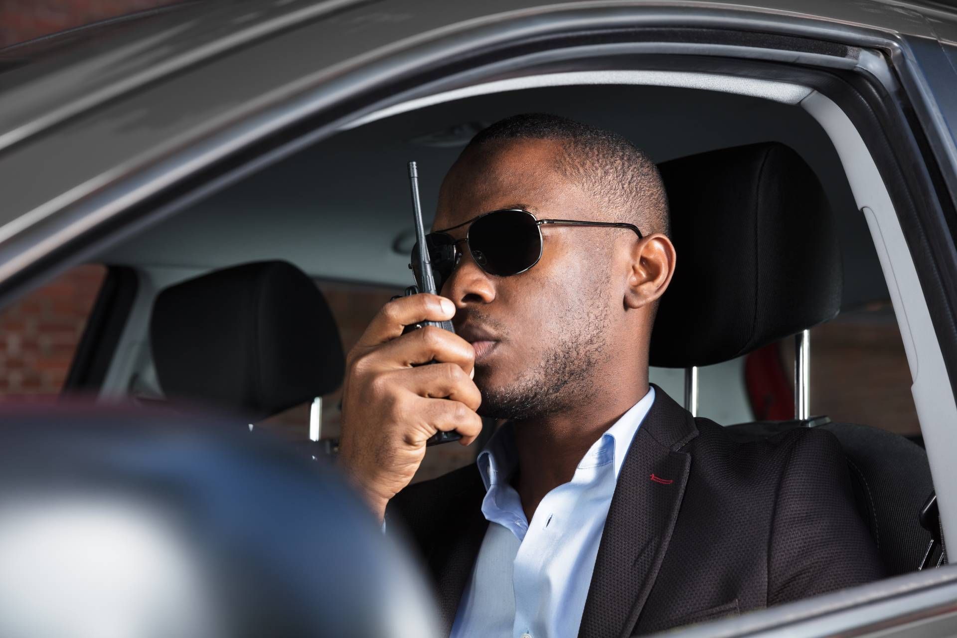 A private security professional talking on a walkie-talkie near Lexington, KY