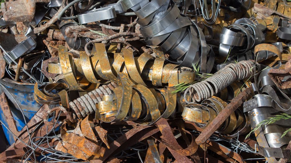 Pile of Metal Scraps, Including Coiled Brass, Springs, and Rusty Iron Pieces  — B & B Scrap Metal in Noosa, QLD
