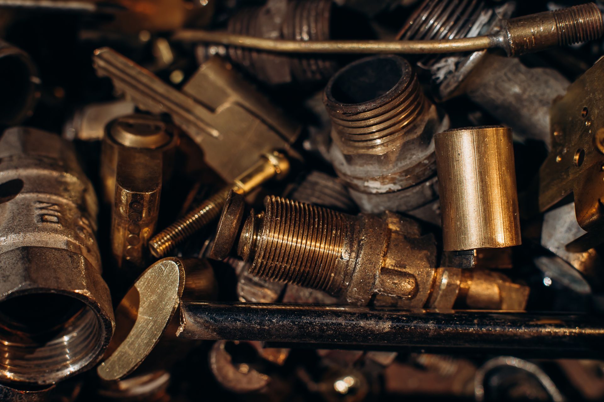 Pile of Various Brass Plumbing Fittings, Close-up  — B & B Scrap Metal in Noosa, QLD