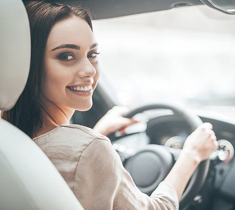 Auto Insurance Service — Woman Smiling Inside Car in Bountiful, UT