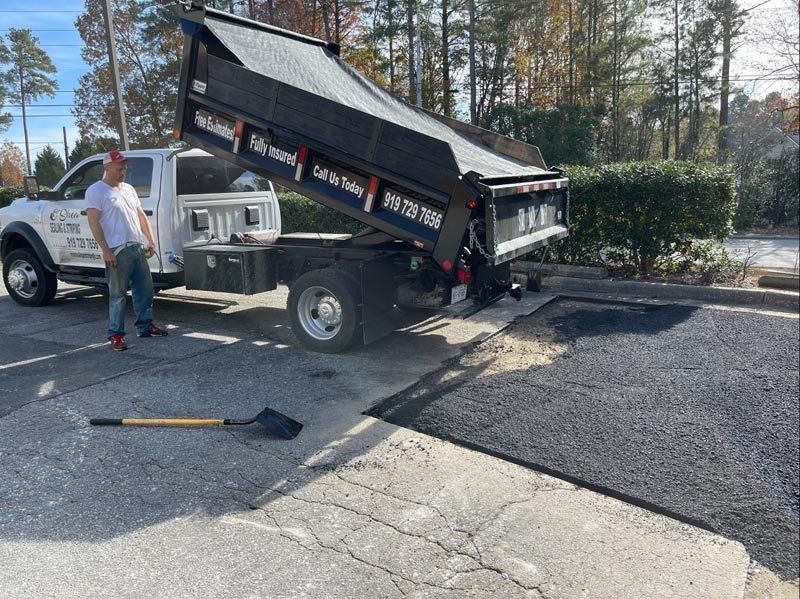 Worker Making Asphalt With Shovels