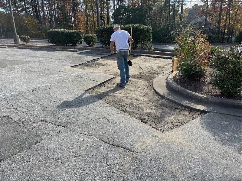 Worker Repairing Asphalt Road