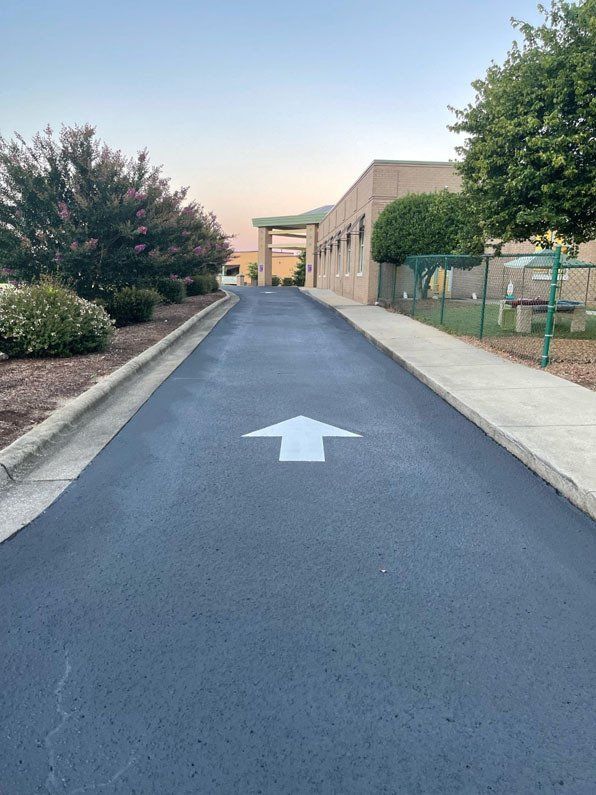 Direction Arrow Symbol On Asphalt Driveway