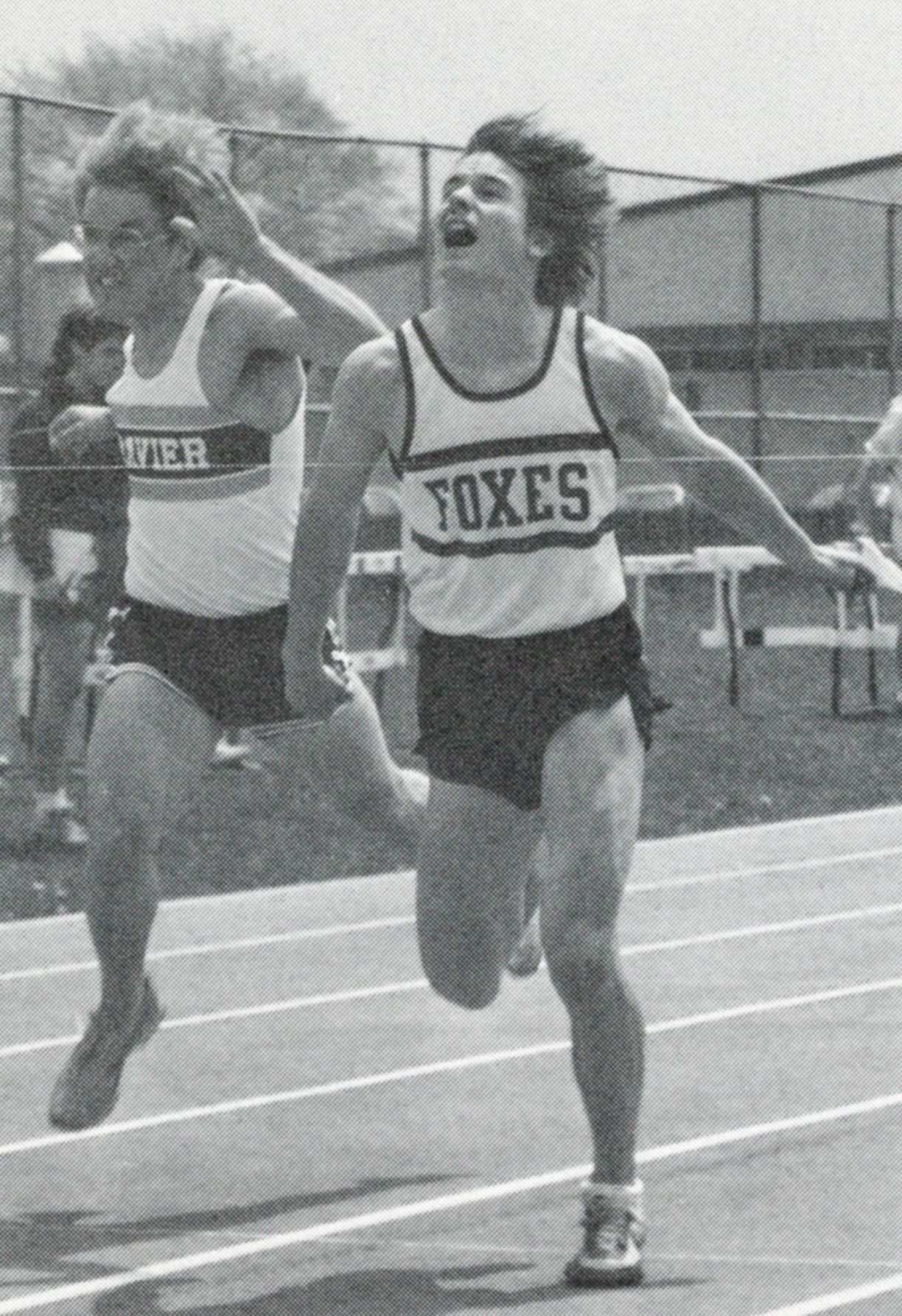 Male track team member in race - just ahead of a competitor from Xavier
