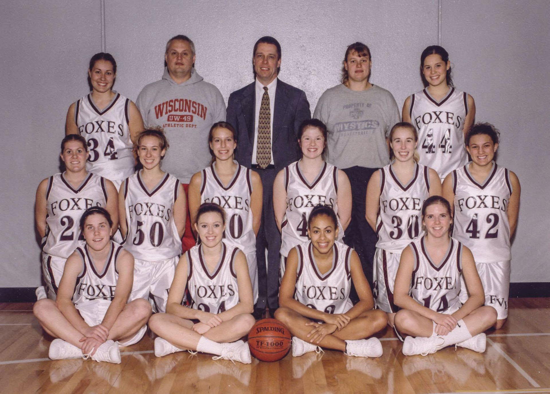Smiling members of the 2002-2003 girls basketball team