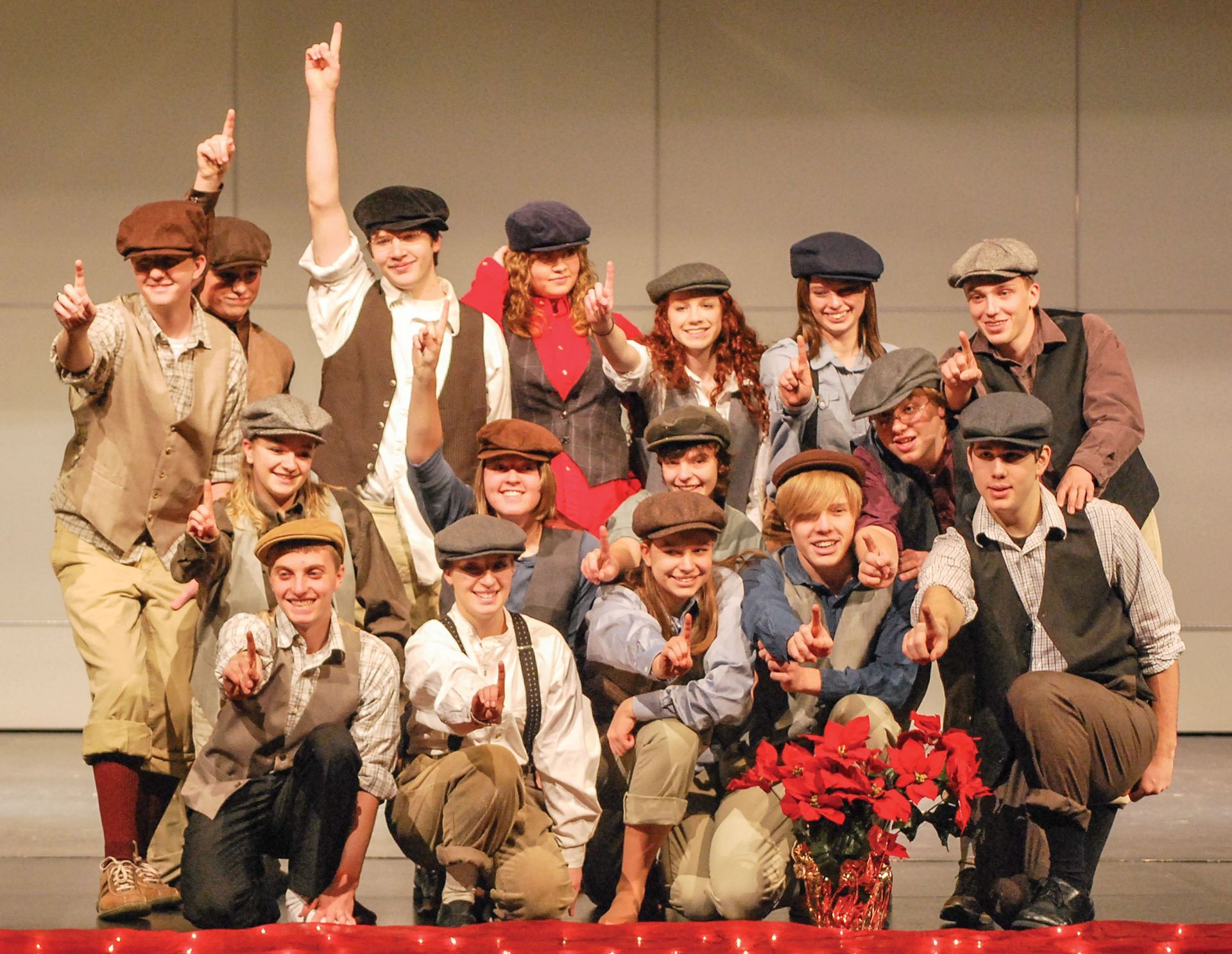 Choraliers dressed in newspaper delivery clothes (sang a song from