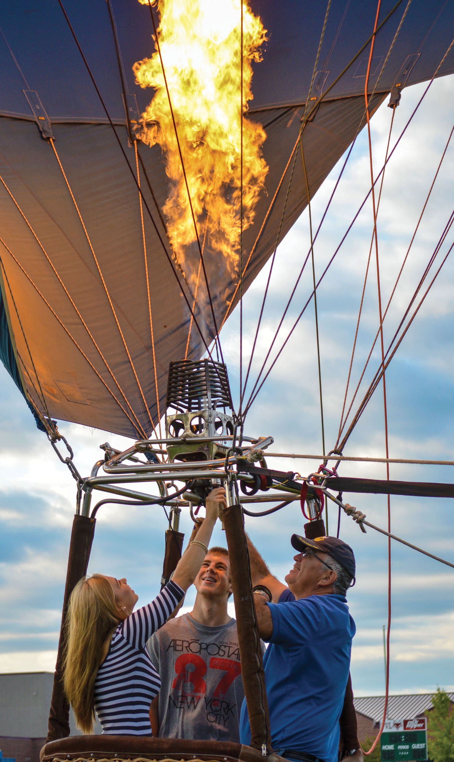 Students in a hot air balloon, adjusting the fuel source