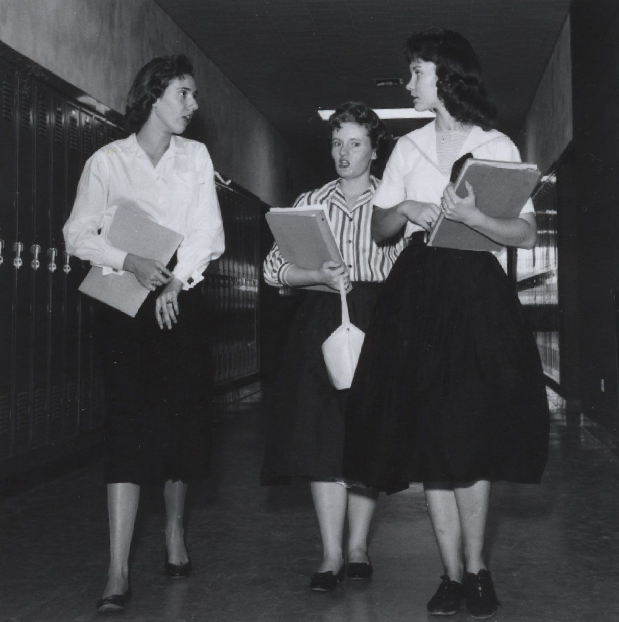Three girls in skirts in the Oneida Street campus of FVL
