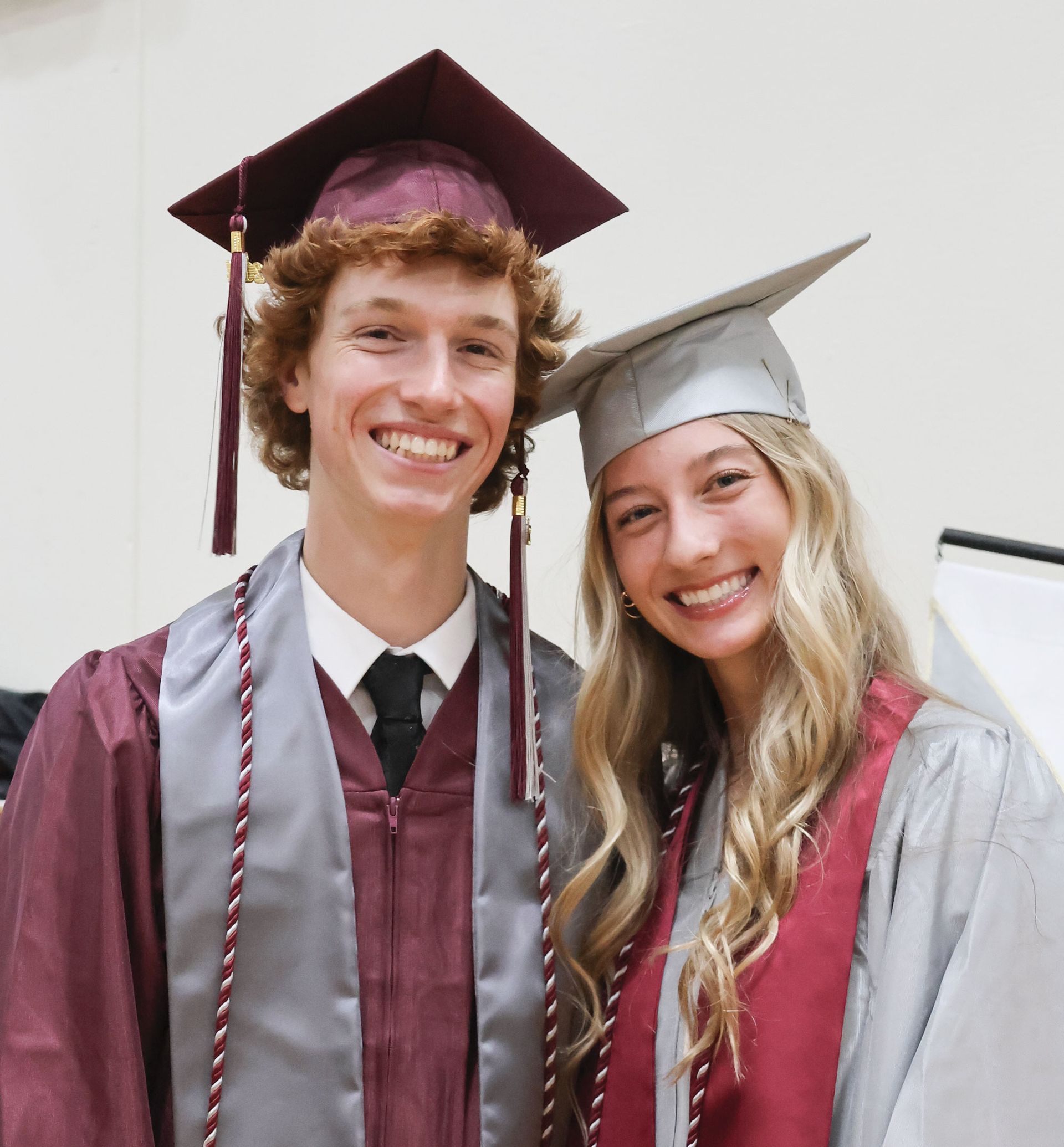Smiling guy and girl graduates, prior to ceremony