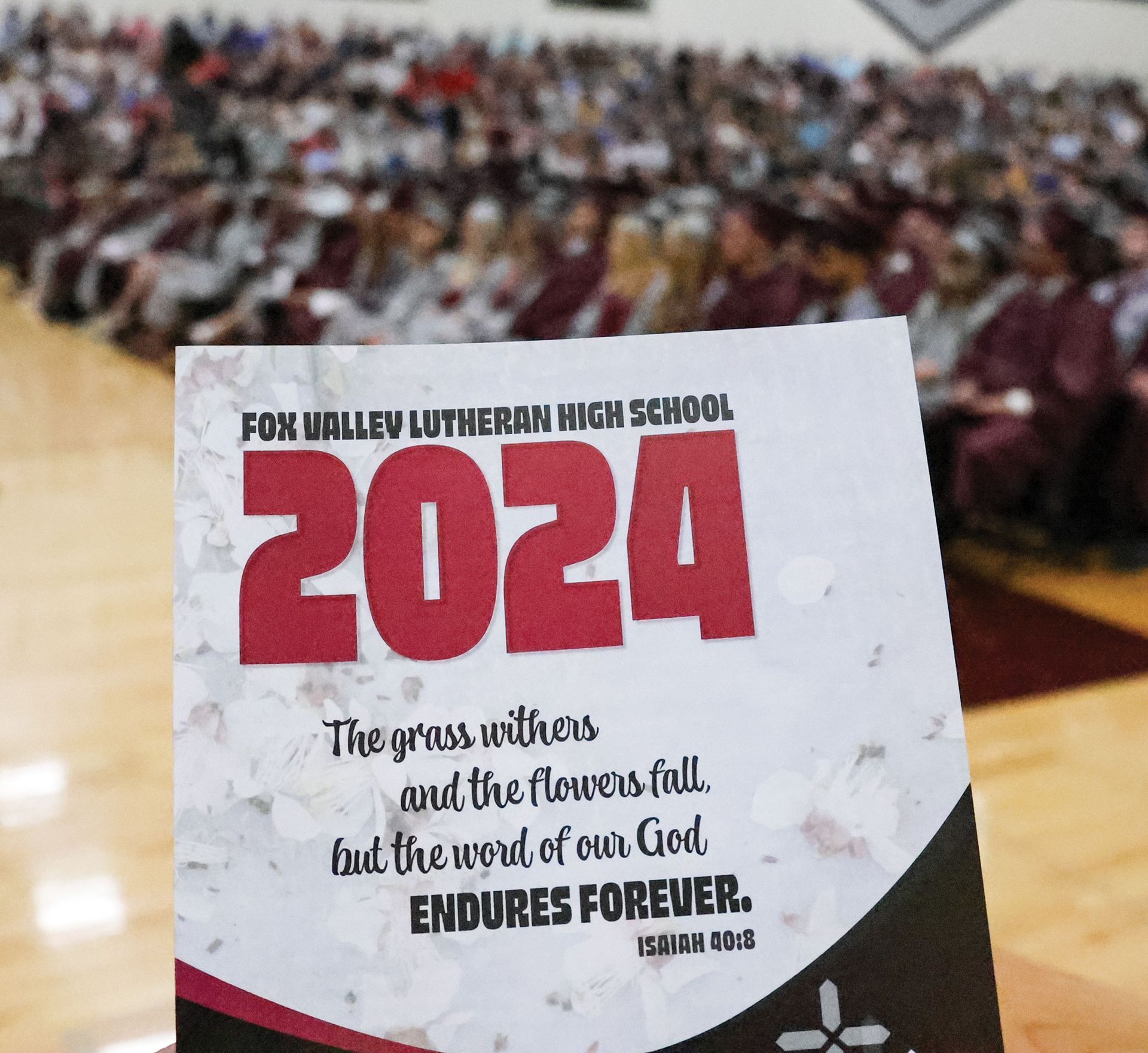 Graduation service folder with full gym in the background