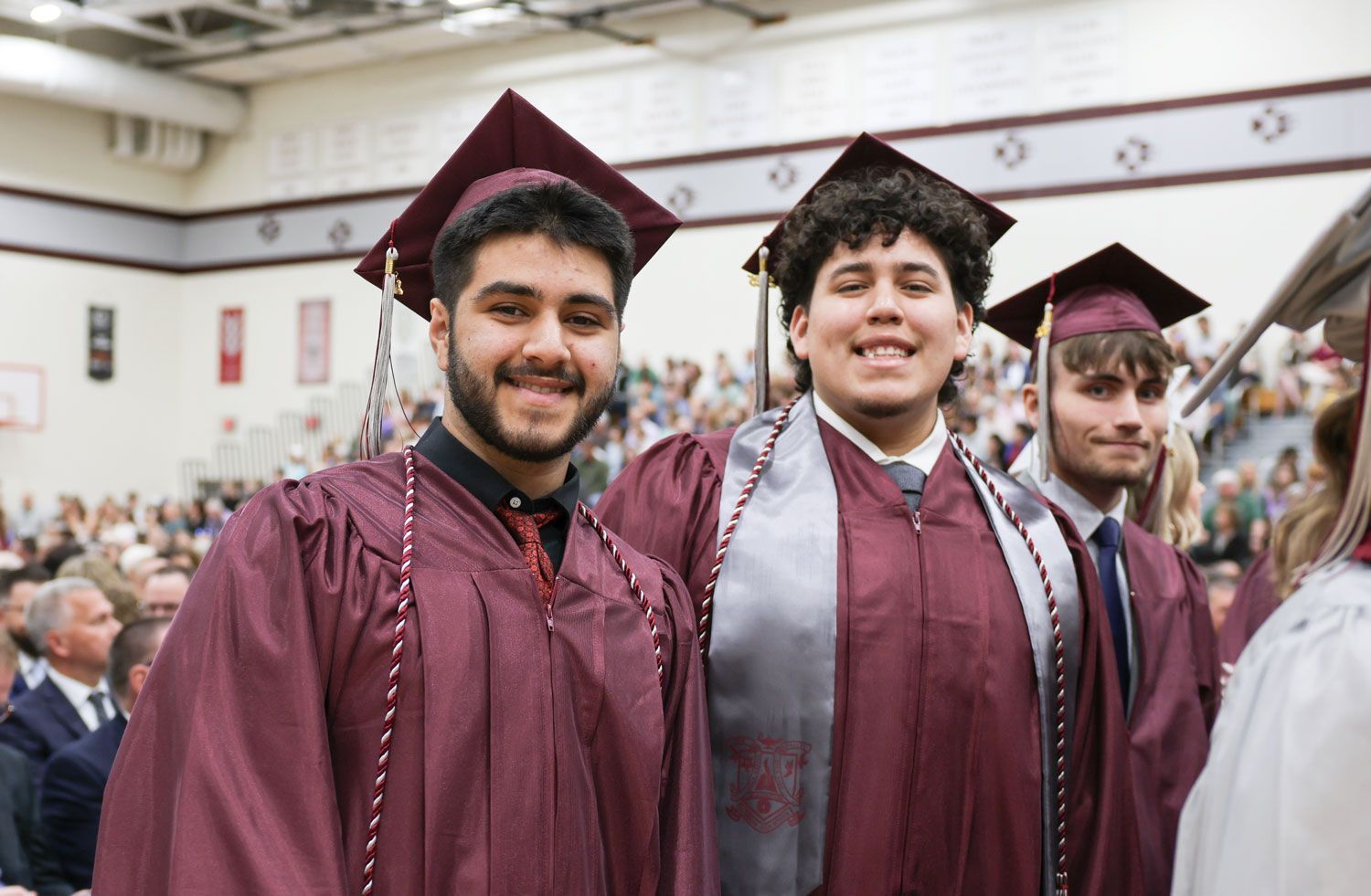 Two smiling male students with arms around each other