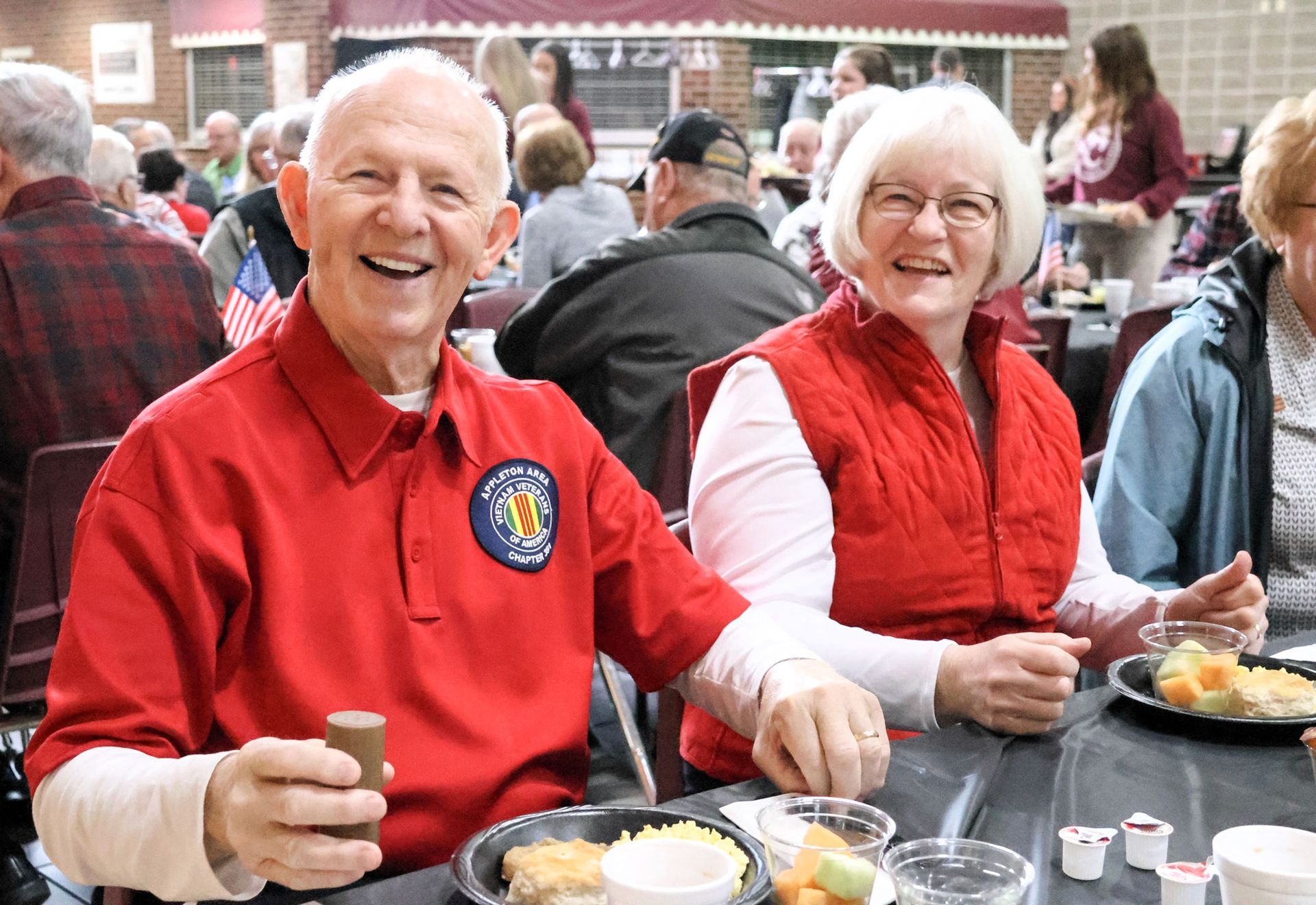Happy couple at a table during the Veterans Day breakfast