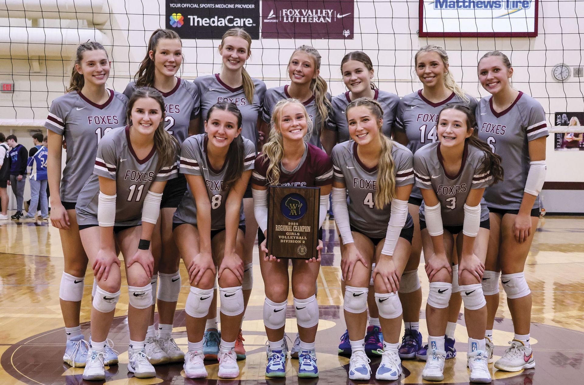 Volleyball team with their Conference Champs plaque