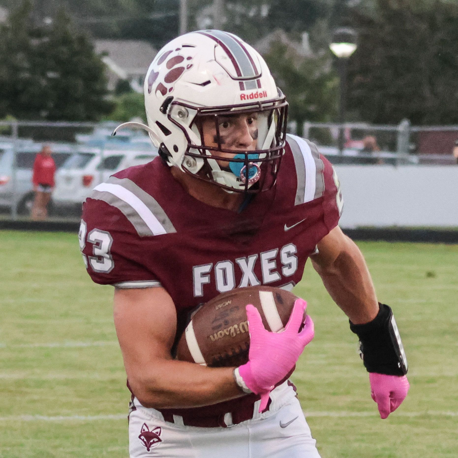 Three football players on the field during a game