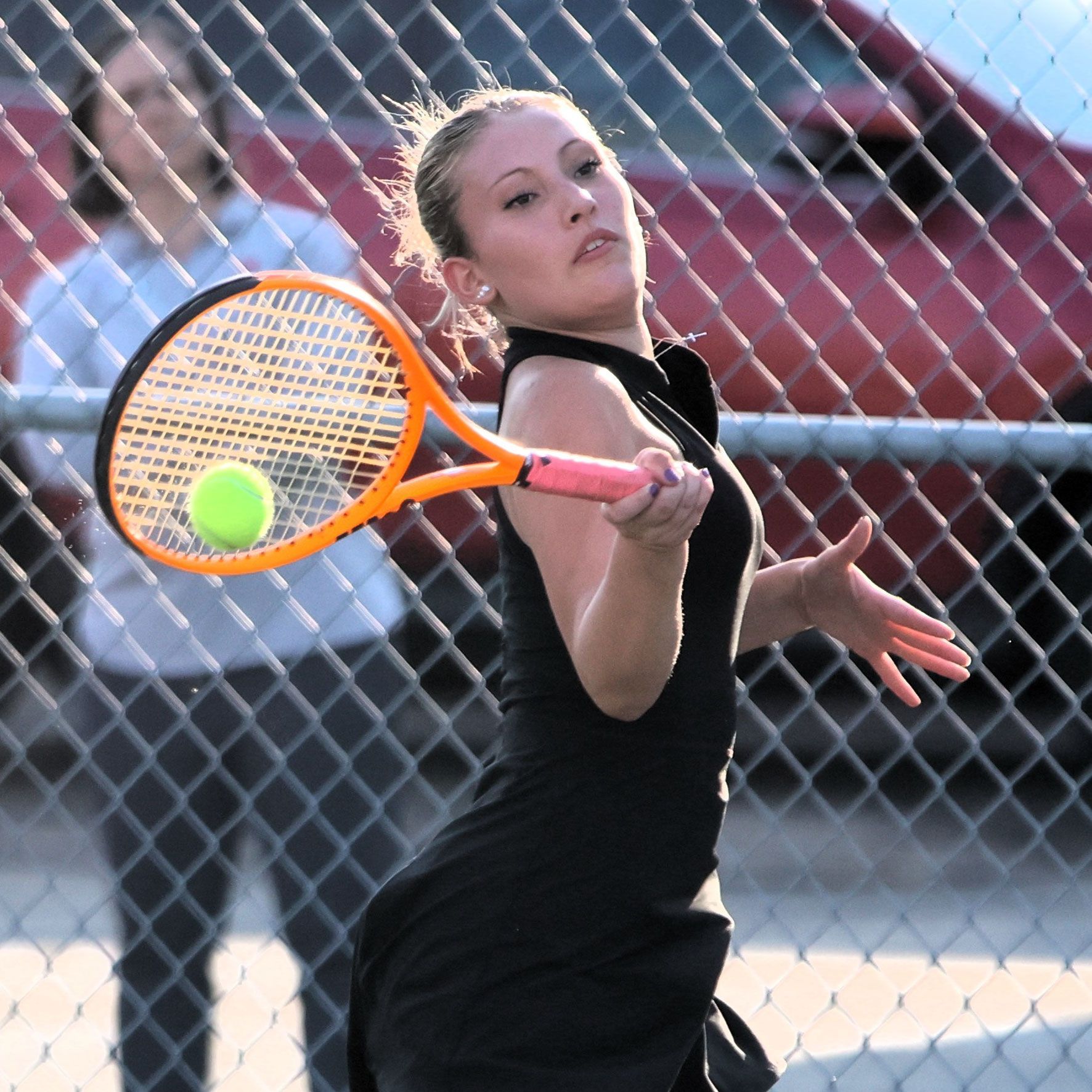 Amelia hitting the ball during a match