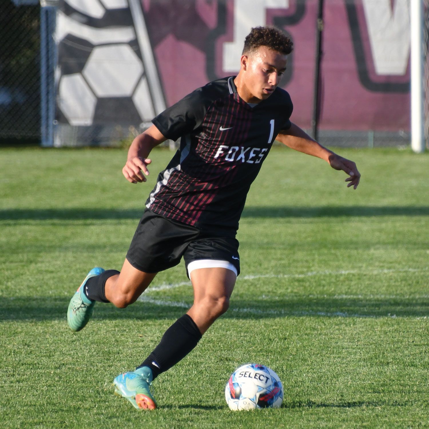 Soccer players running after the ball