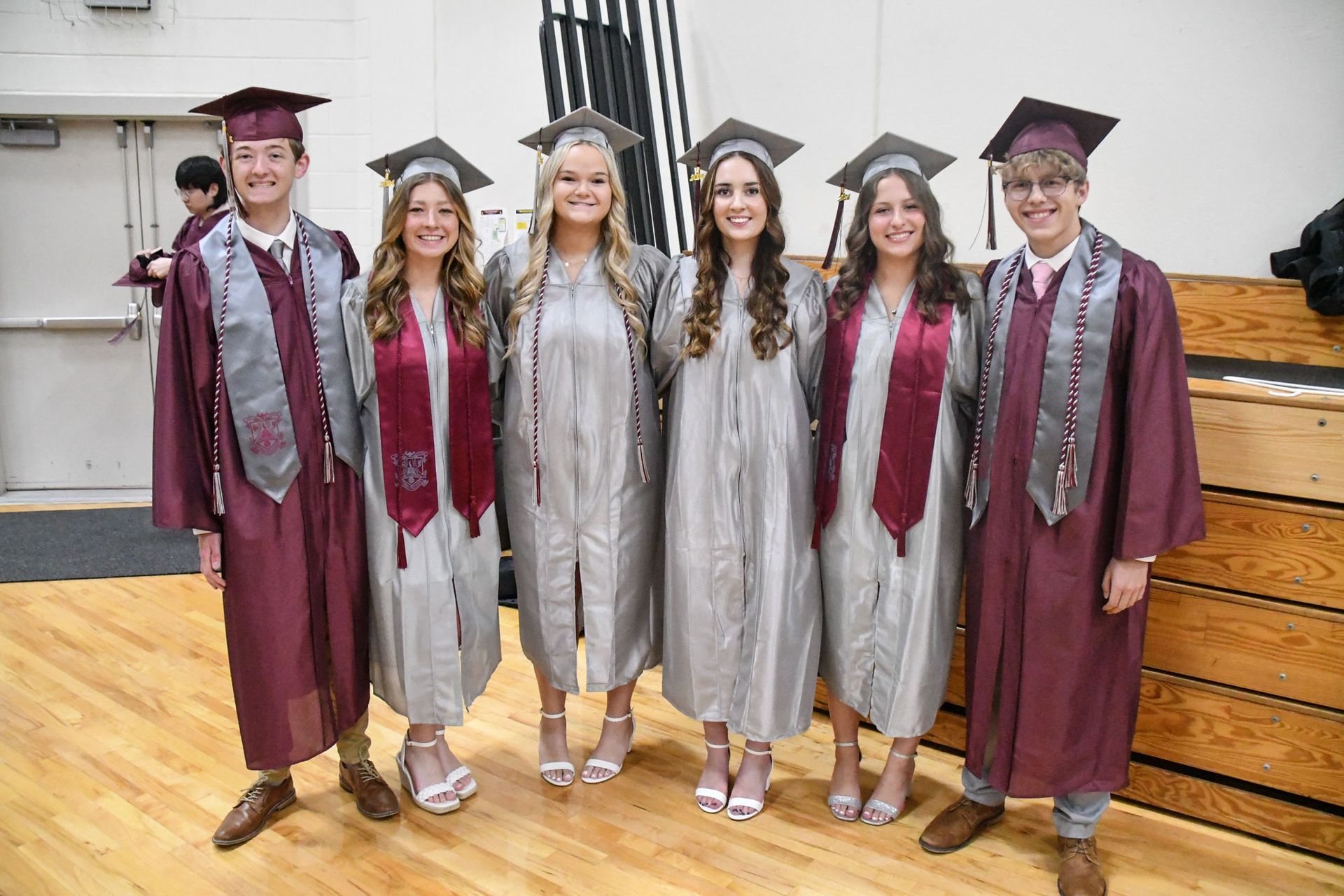 Group of smiling boy and girl graduates