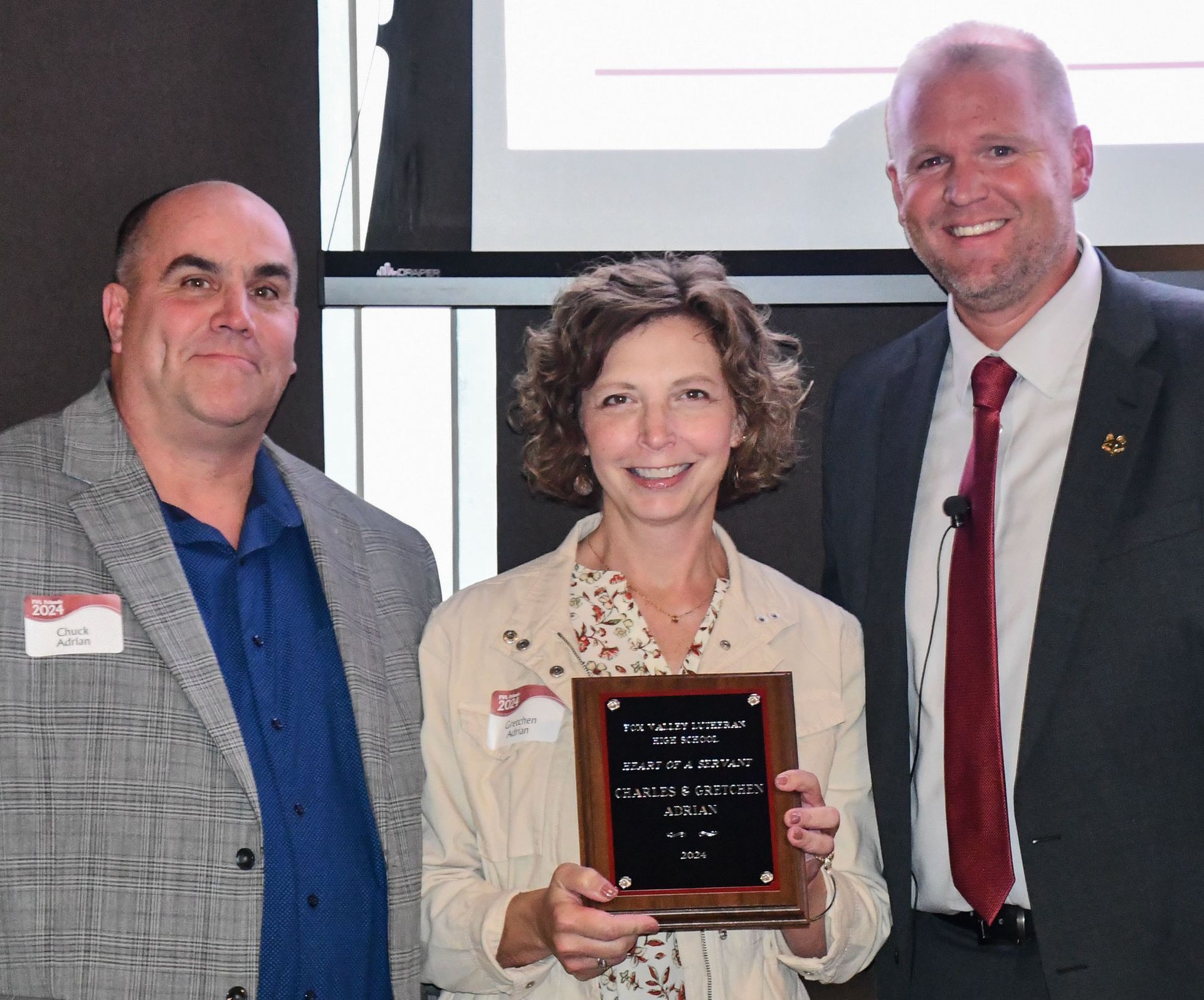 President Loberger with Jon and Susan Gossens, who are holding up their Heart of a Servant plaque