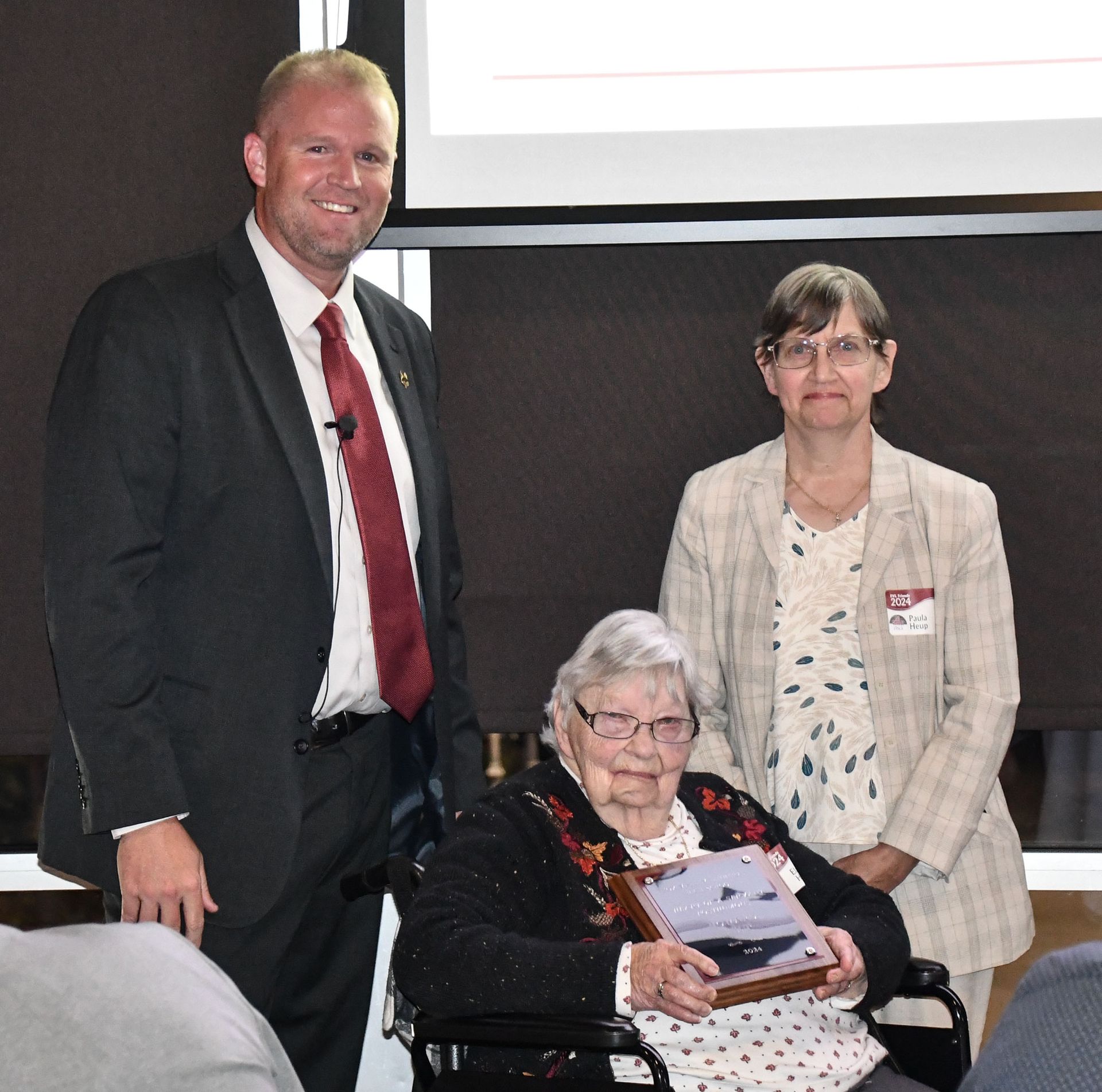 President Loberger with the family of Earl Semrow, holding up his plaque