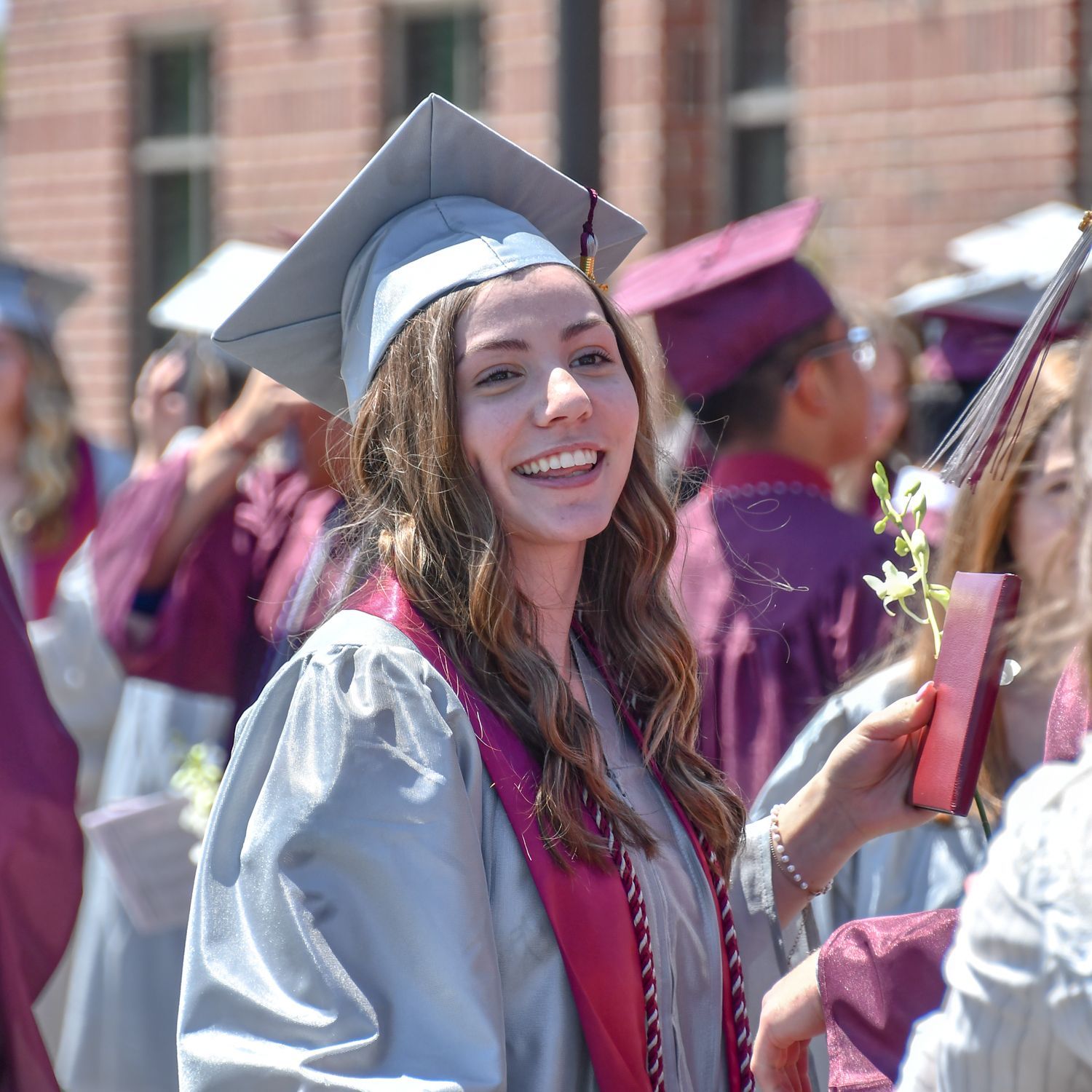 Happy female student, outside, after the ceremony