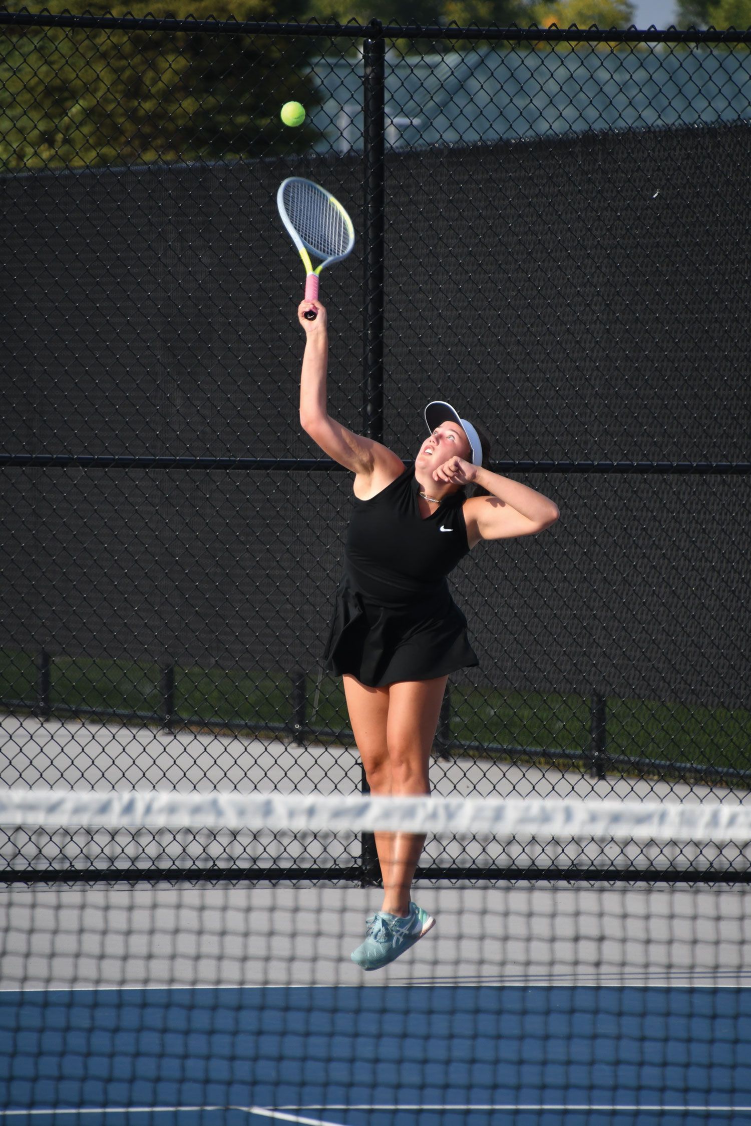 Amelia hitting the ball during a match