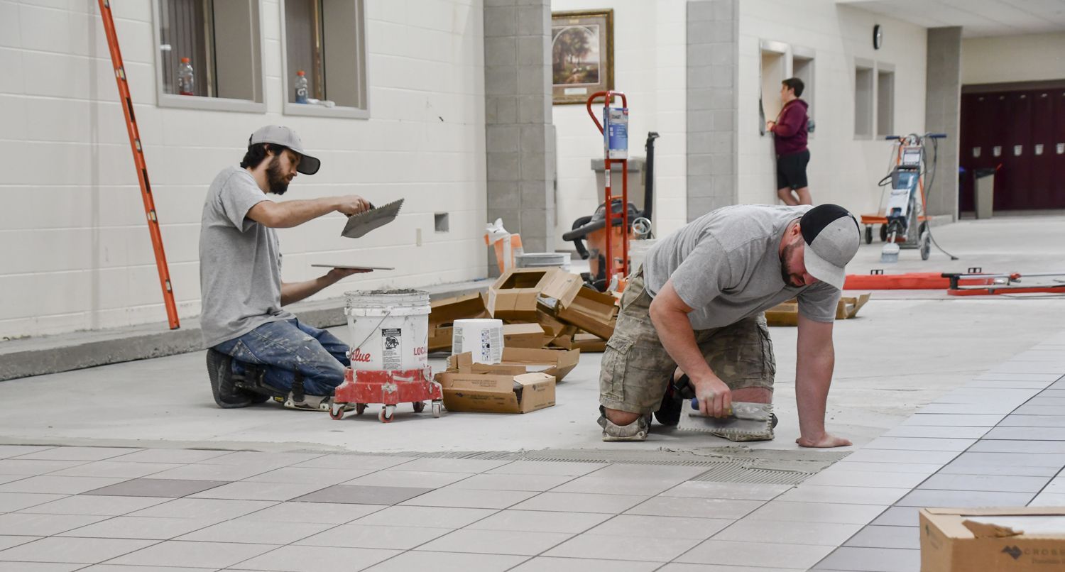 Tile being laid in the area that used to be the pits