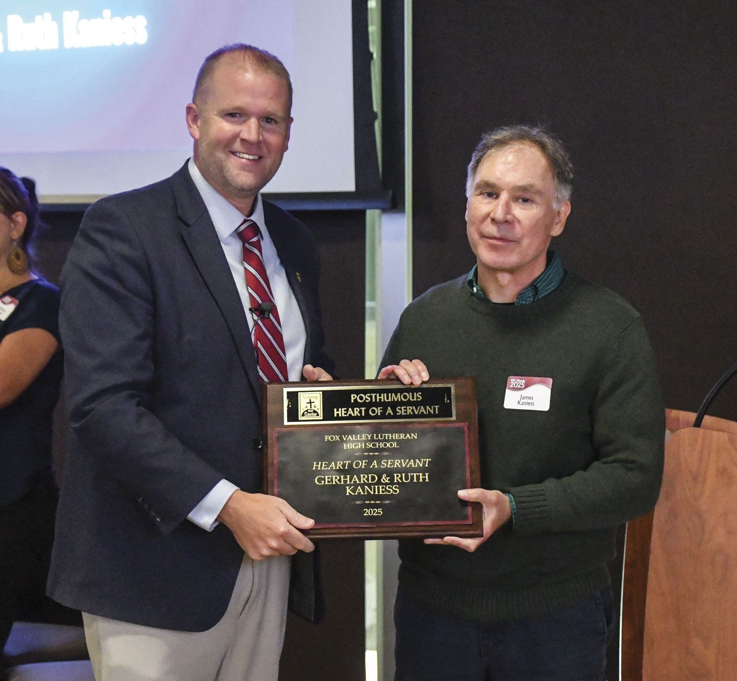 President Loberger with the family of Earl Semrow, holding up his plaque