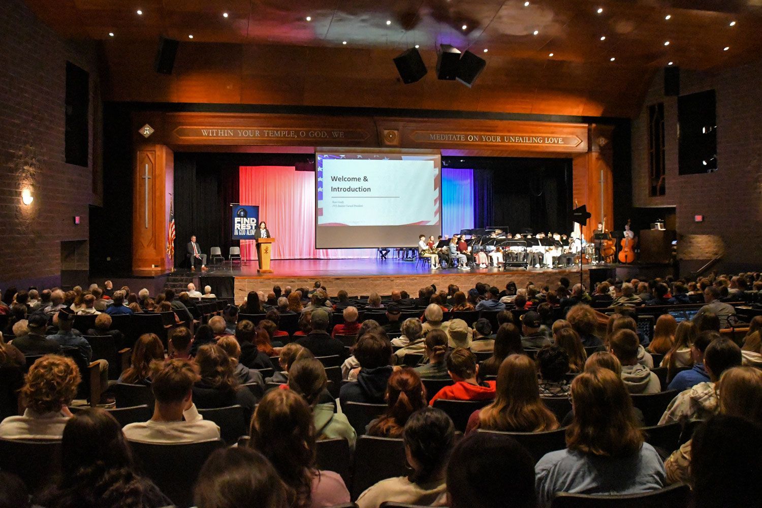 View of filled auditorium and stage  from the back