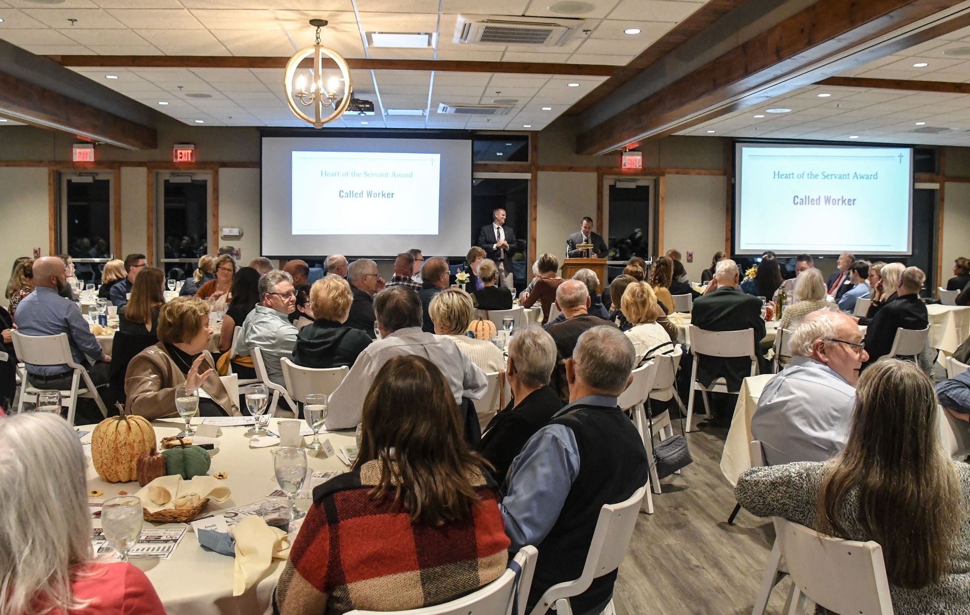 Broad view of Friends Dinner at Bubolz with everyone seated at tables