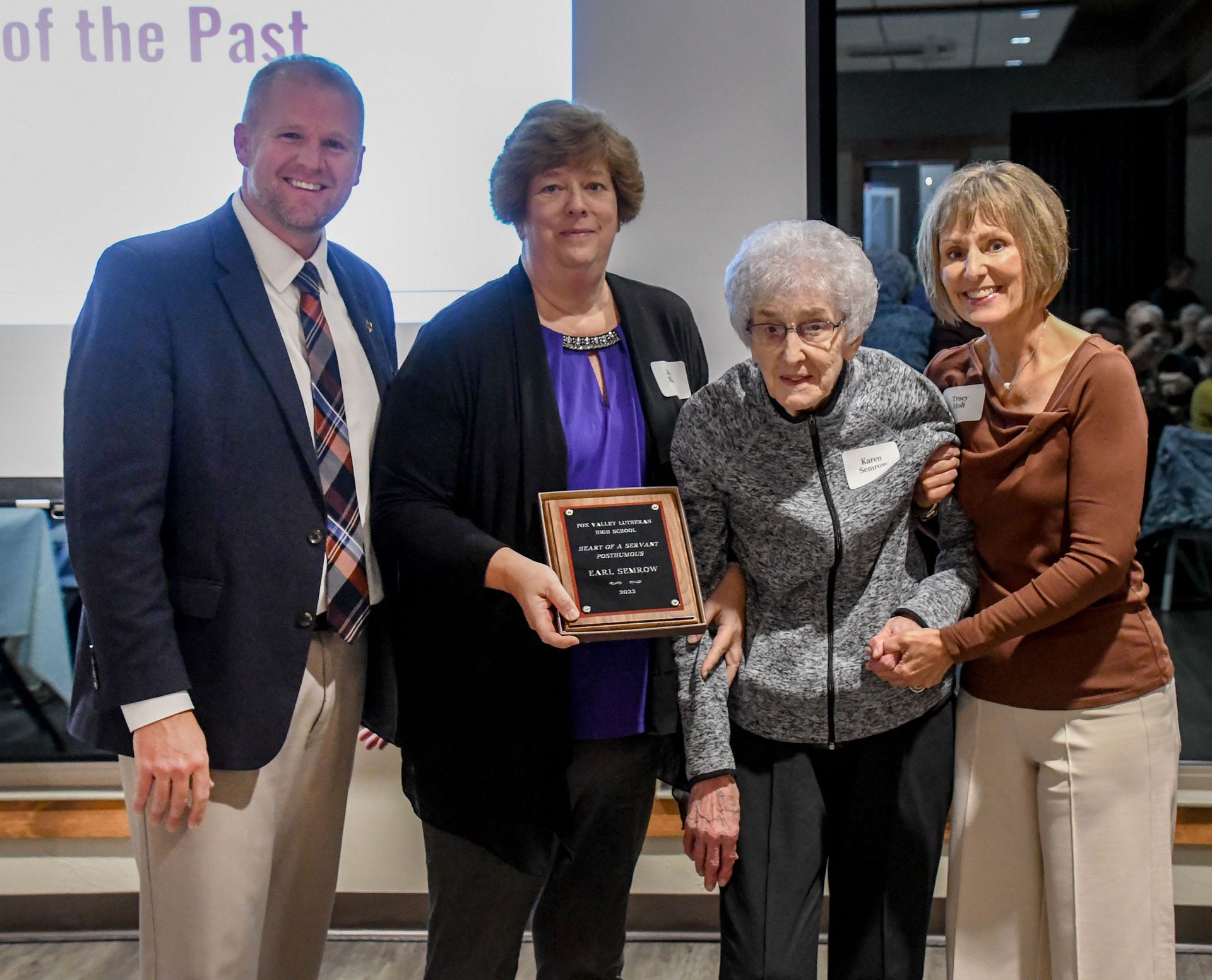 President Loberger with the family of Earl Semrow, holding up his plaque