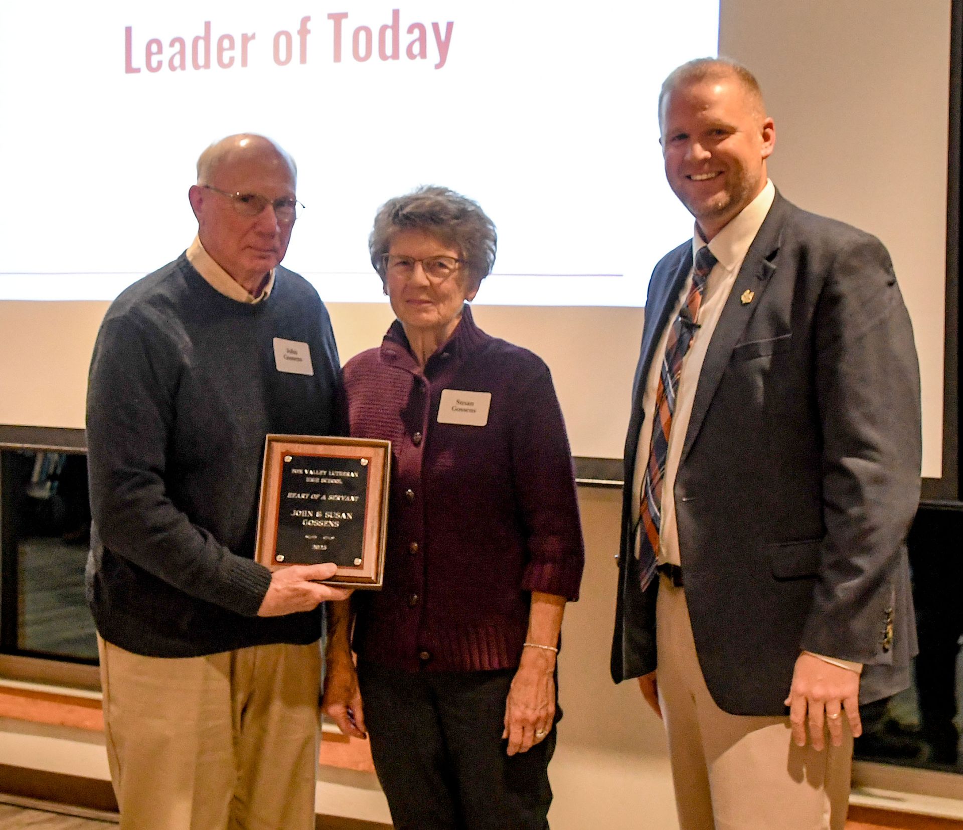President Loberger with Jon and Susan Gossens, who are holding up their Heart of a Servant plaque