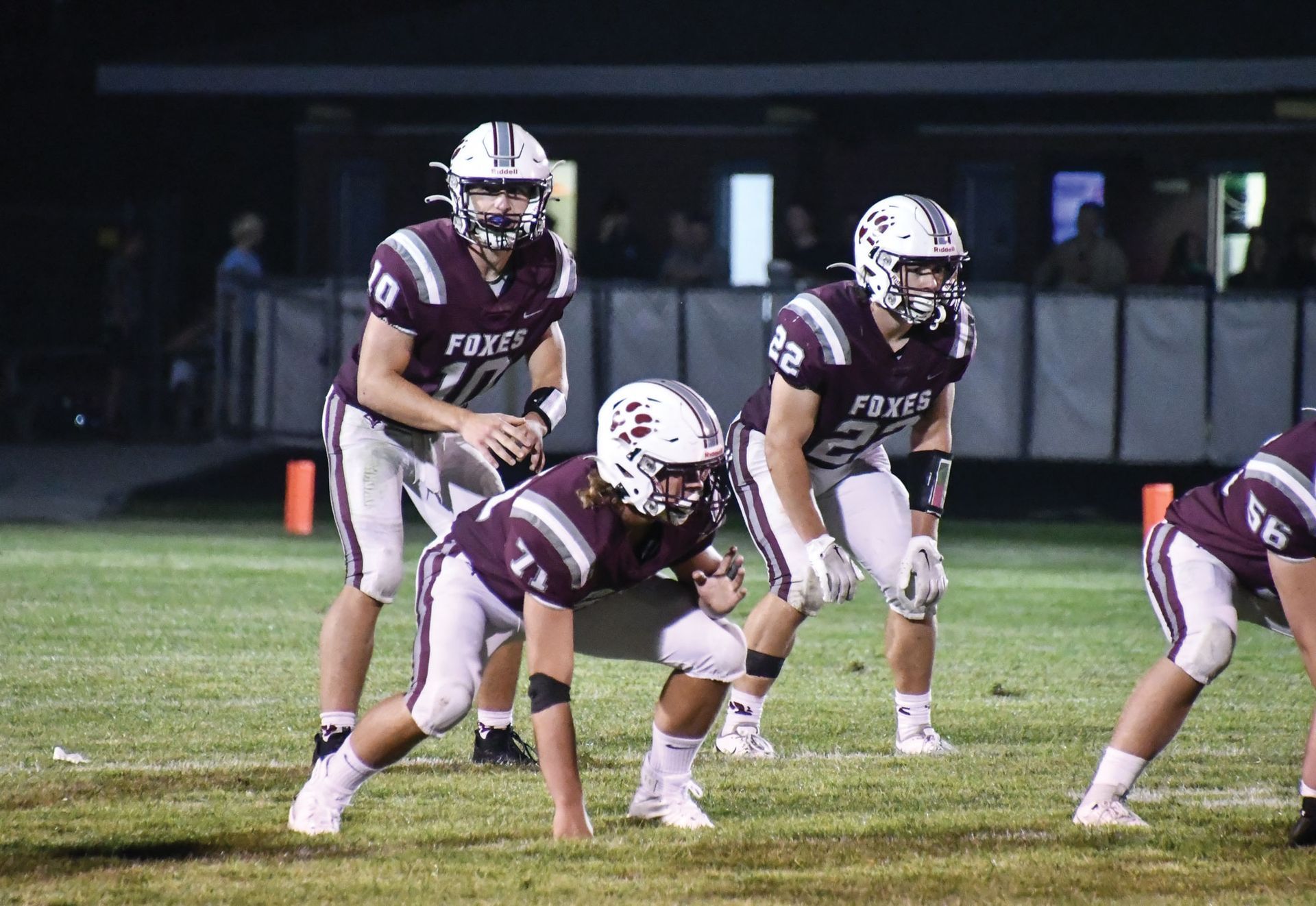 Three football players on the field during a game