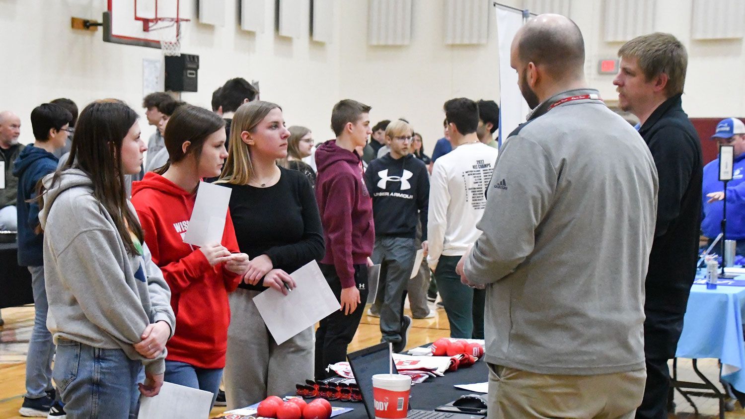 Students visiting a table during the summer job fair