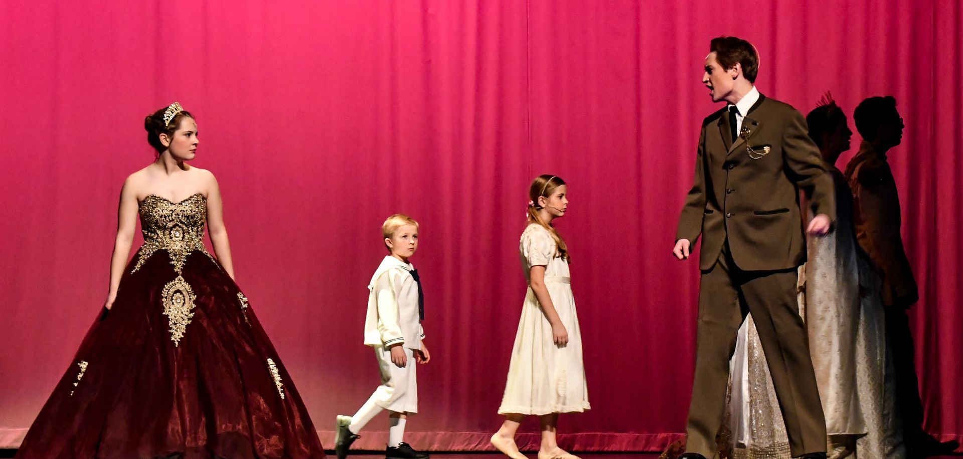 Anastasia on stage with two children and a man