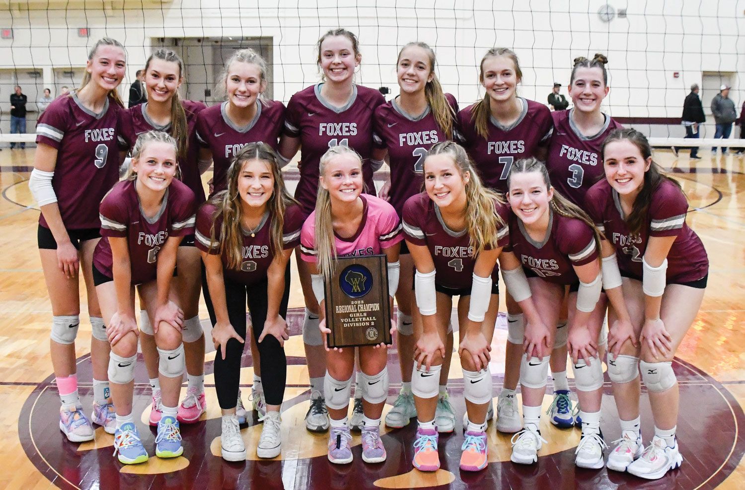 Volleyball team with their Conference Champs plaque