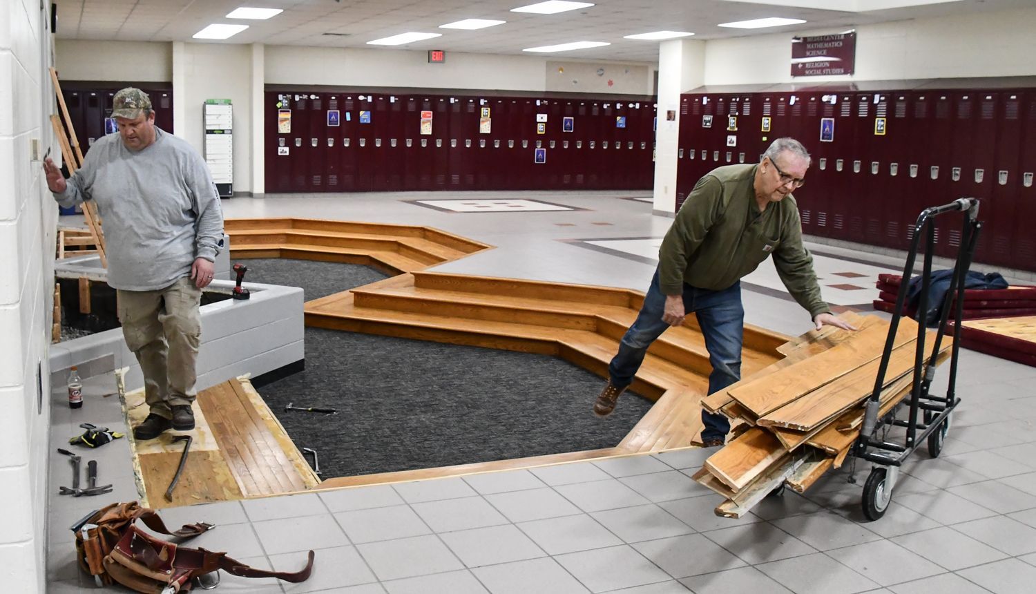 Wood from the pits seating area being piled onto a cart