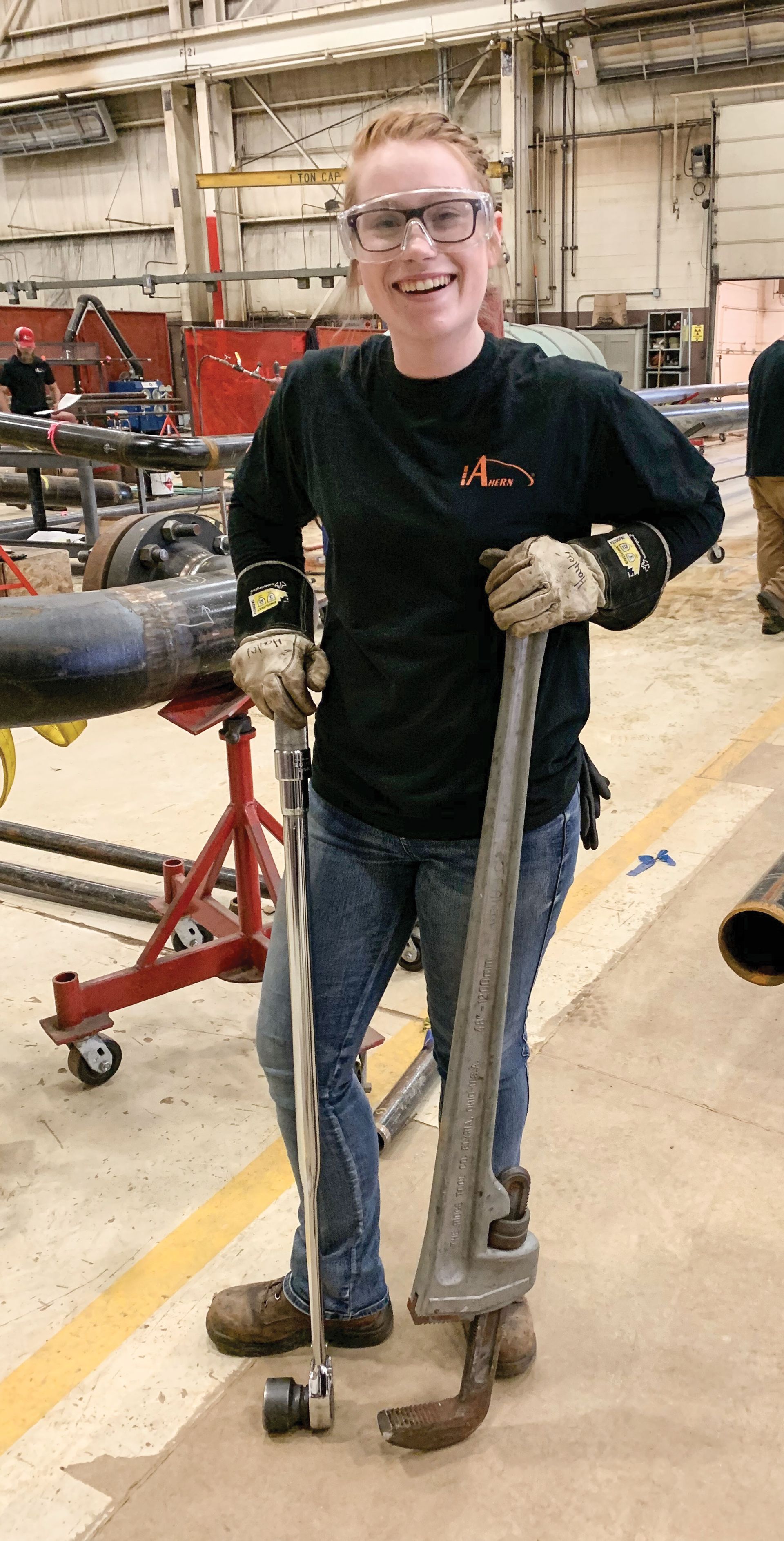 Smiling girl wearing goggles at a youth apprenticeship location