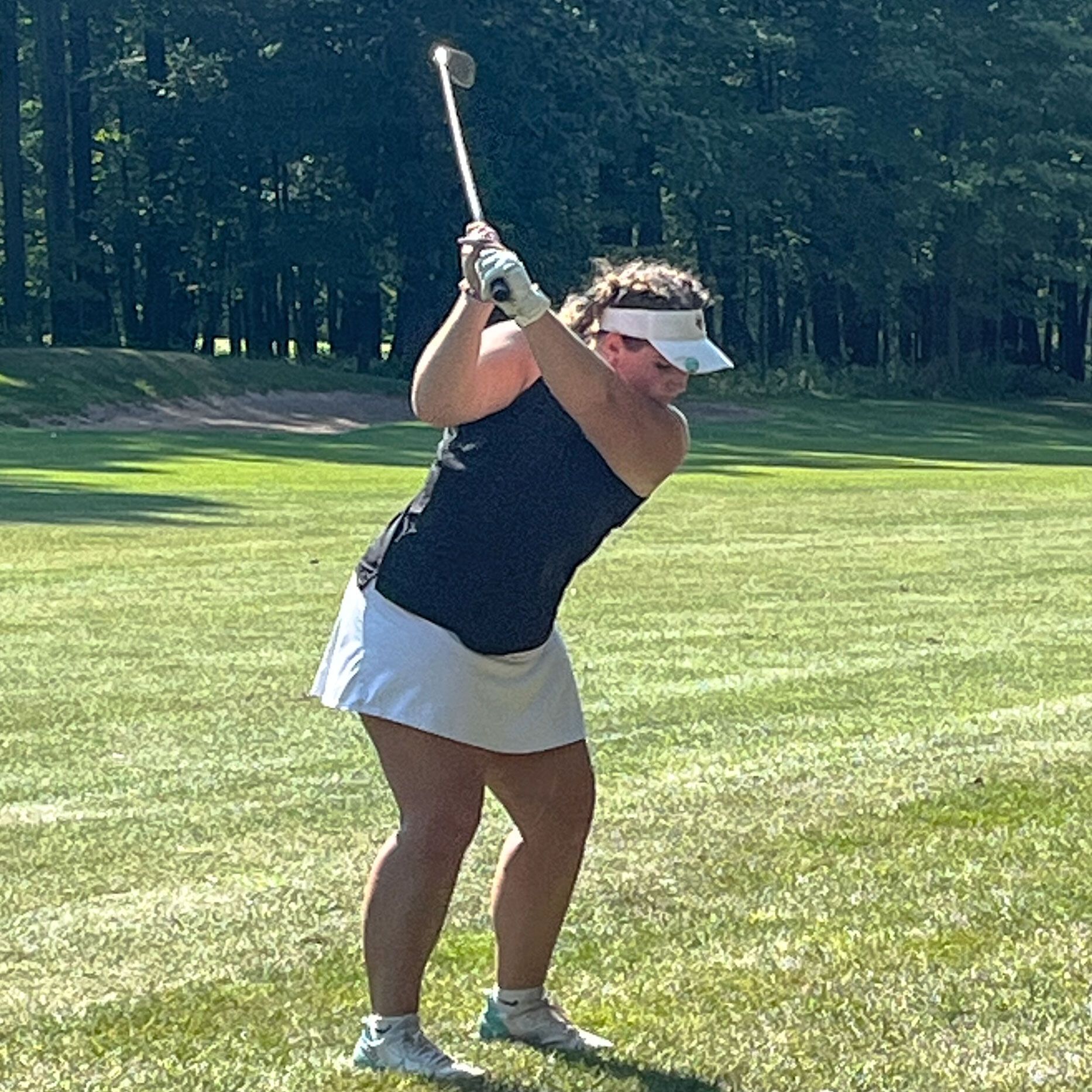 Lauren Movrich taking a swing on the golf course