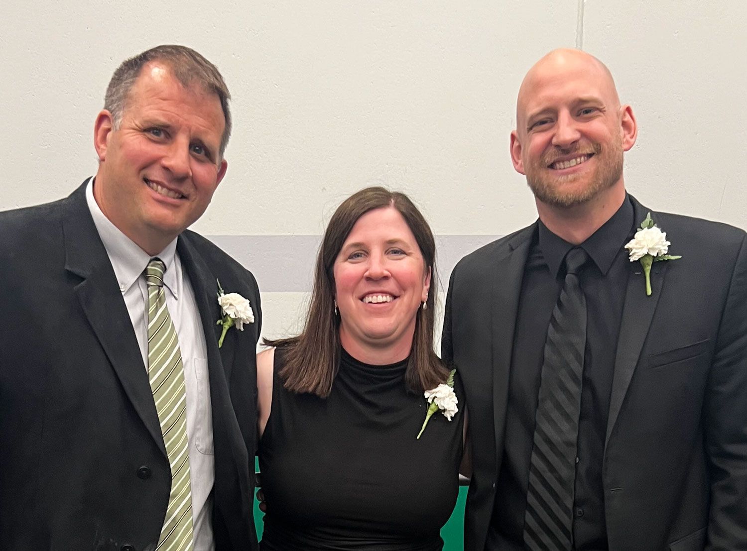 Smiling Rachel in the middle, one smiling assistant principals on each side of her